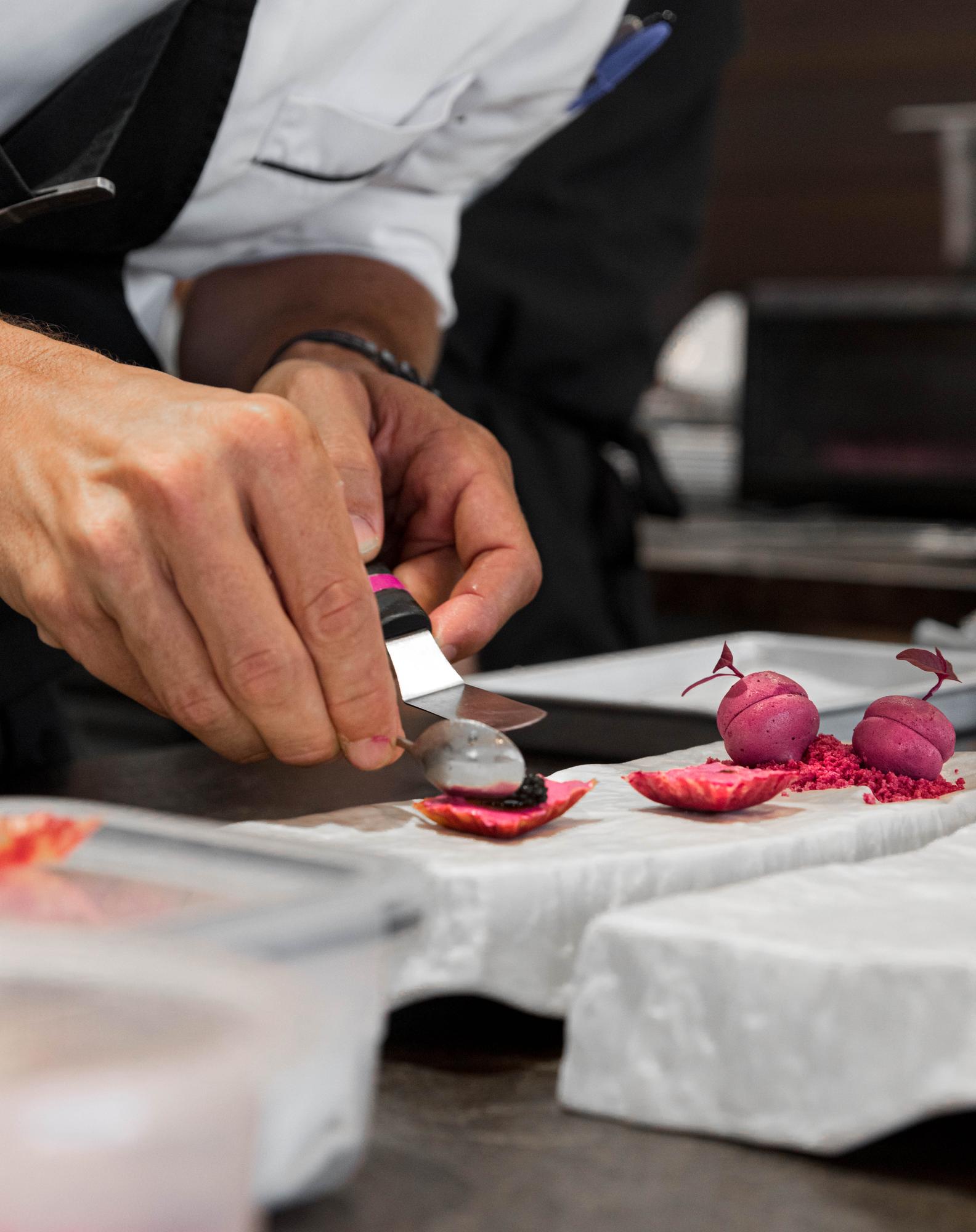 chef demonstrating knife technique to small group
